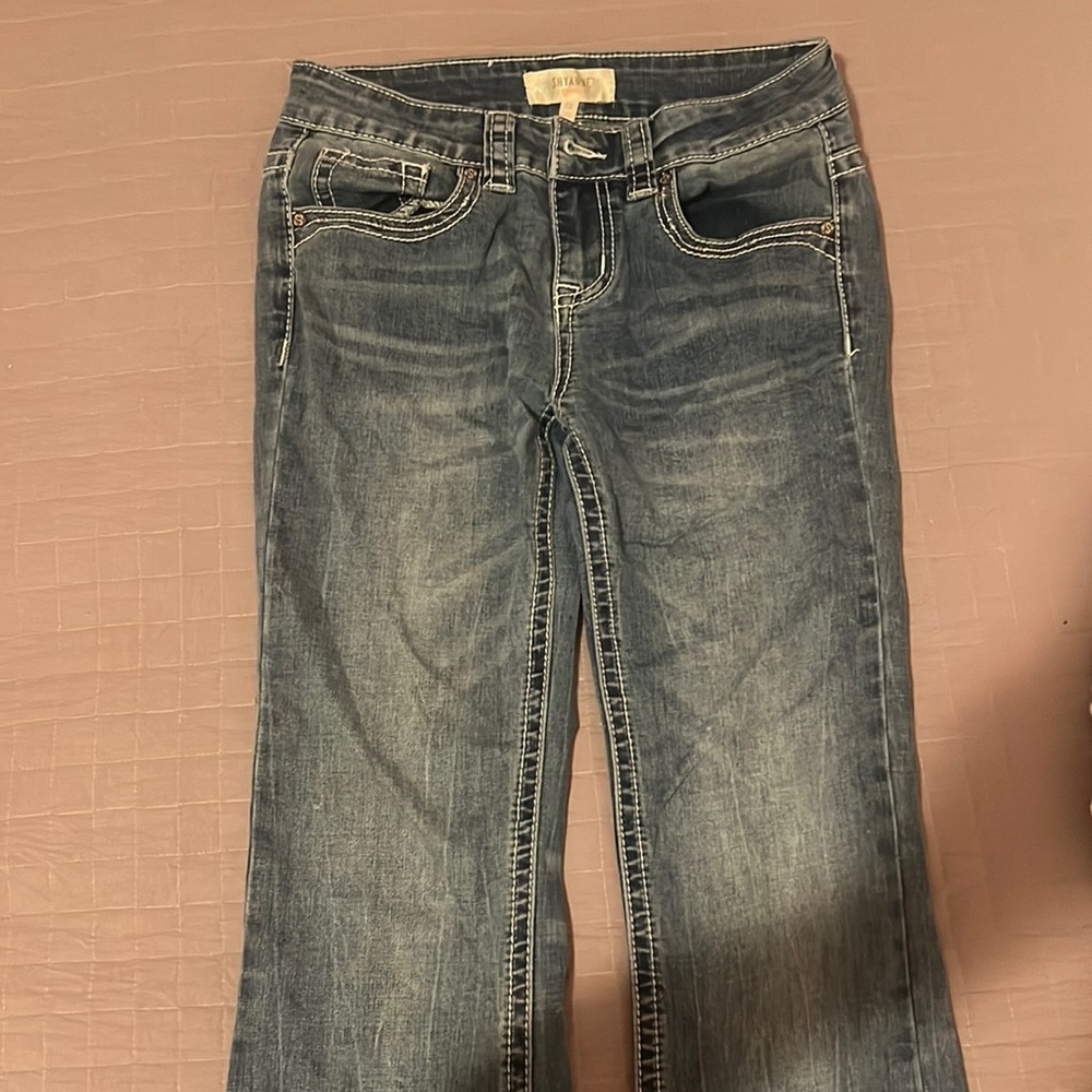 light blue bootcut jeans with animal imprint on back pockets